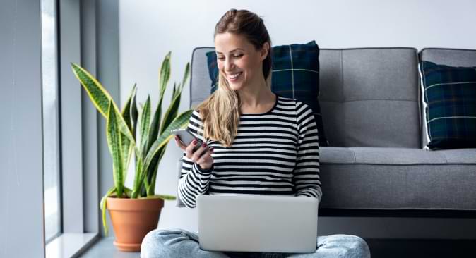 Woman smiling looking at her mobile phone.