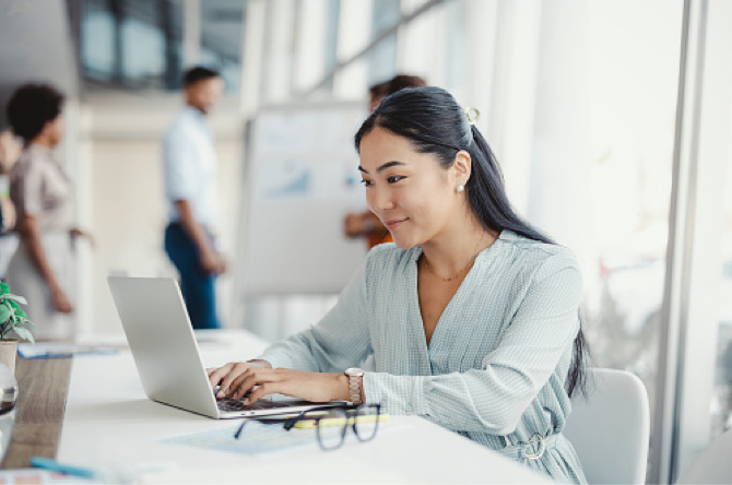 Smiling woman using laptop