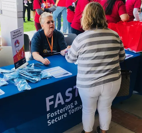 Above: An employee answers questions about FAST at a National Adoption Day event