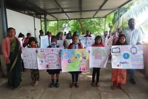 Children hold up posters they made when learning about Cyber Safety